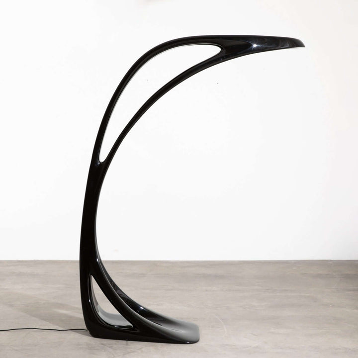 Sculptural floor lamp with sleek black design, perfect as an art deco floor lamp for chic living room decor.