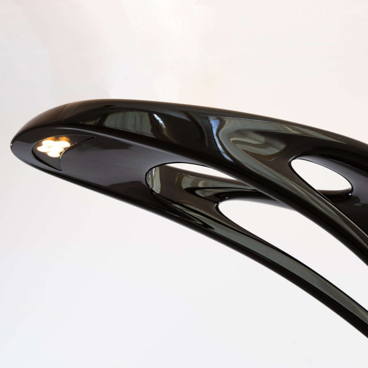 Sculptural art deco floor lamp showcasing a sleek black design, perfect for modern living room lighting.