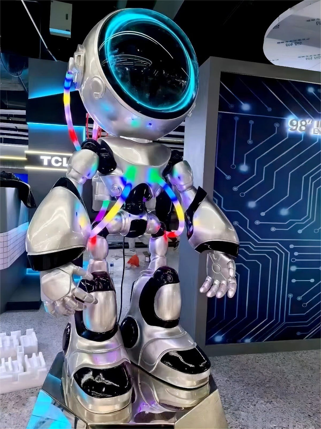 Colorful robotic astronaut figure with light accents, set against a futuristic background of circuitry design.