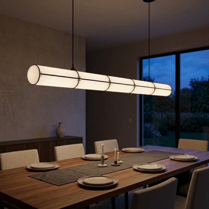Black Acrylic Endless pendant light illuminating a large wood dining table in an evening interior