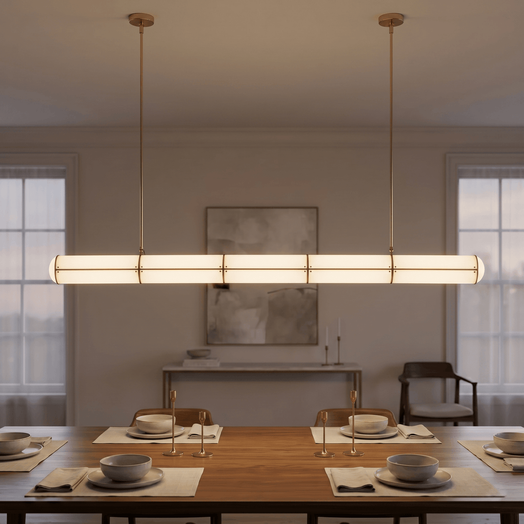 Brass Acrylic Endless linear LED pendant light centered above a set dining table in a softly lit room
