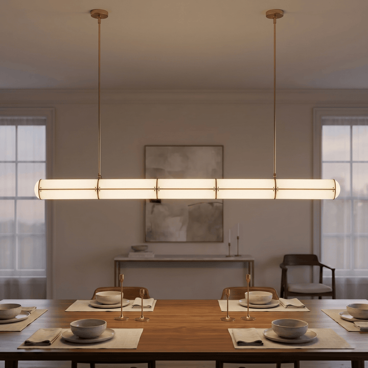 Brass Acrylic Endless linear LED pendant light centered above a set dining table in a softly lit room