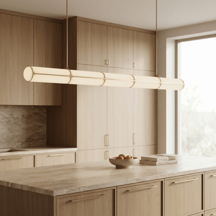 Angled view of the brass Acrylic Endless kitchen island pendant light in a light wood kitchen