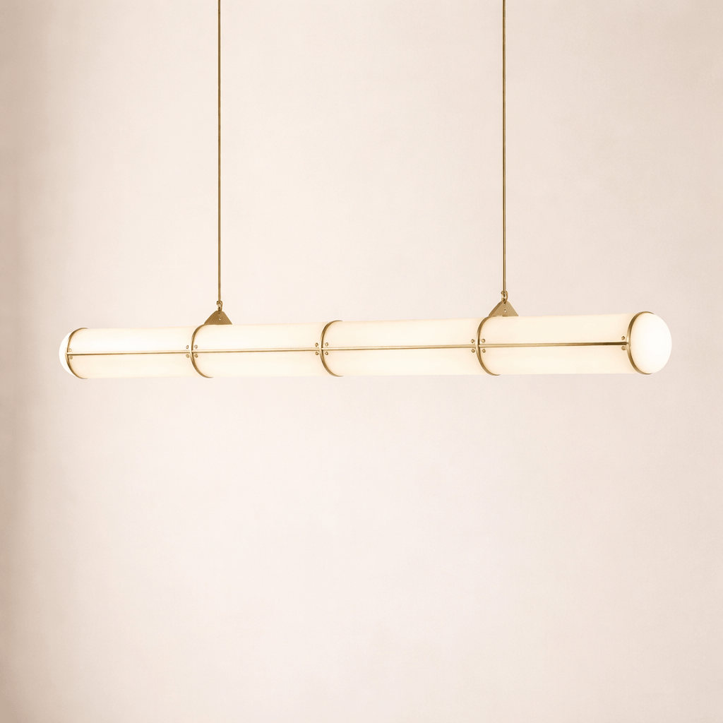 Illuminated brass Acrylic Endless linear pendant light displayed against a warm neutral background