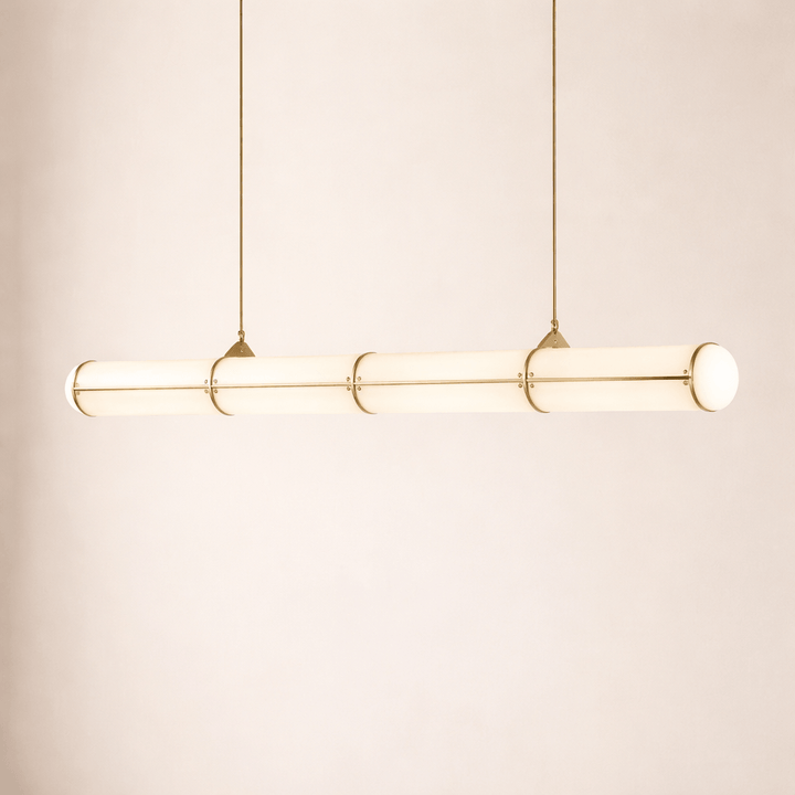 Illuminated brass Acrylic Endless linear pendant light displayed against a warm neutral background