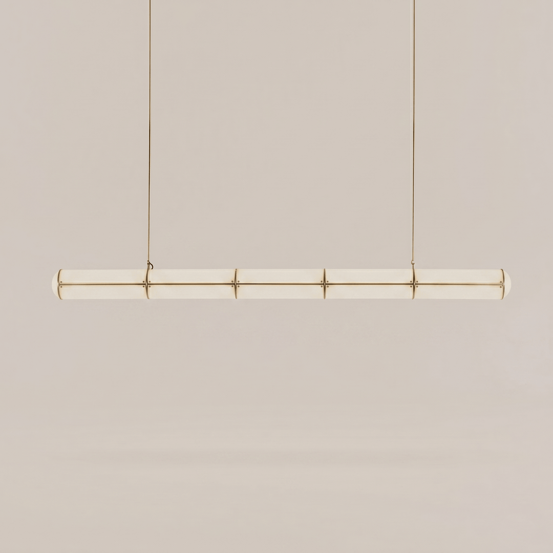 Long brass Acrylic Endless Pendant Light with a segmented frosted acrylic diffuser on a neutral background