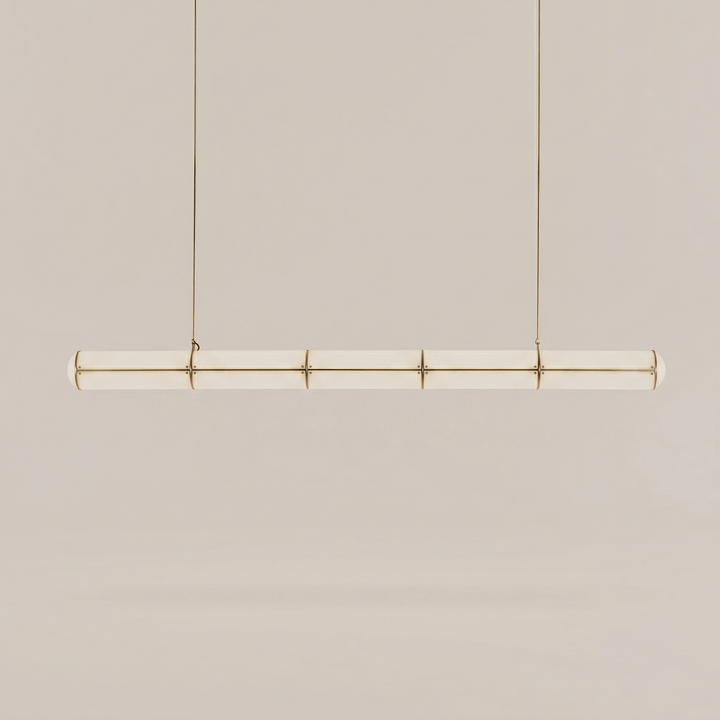 Long brass Acrylic Endless Pendant Light with a segmented frosted acrylic diffuser on a neutral background