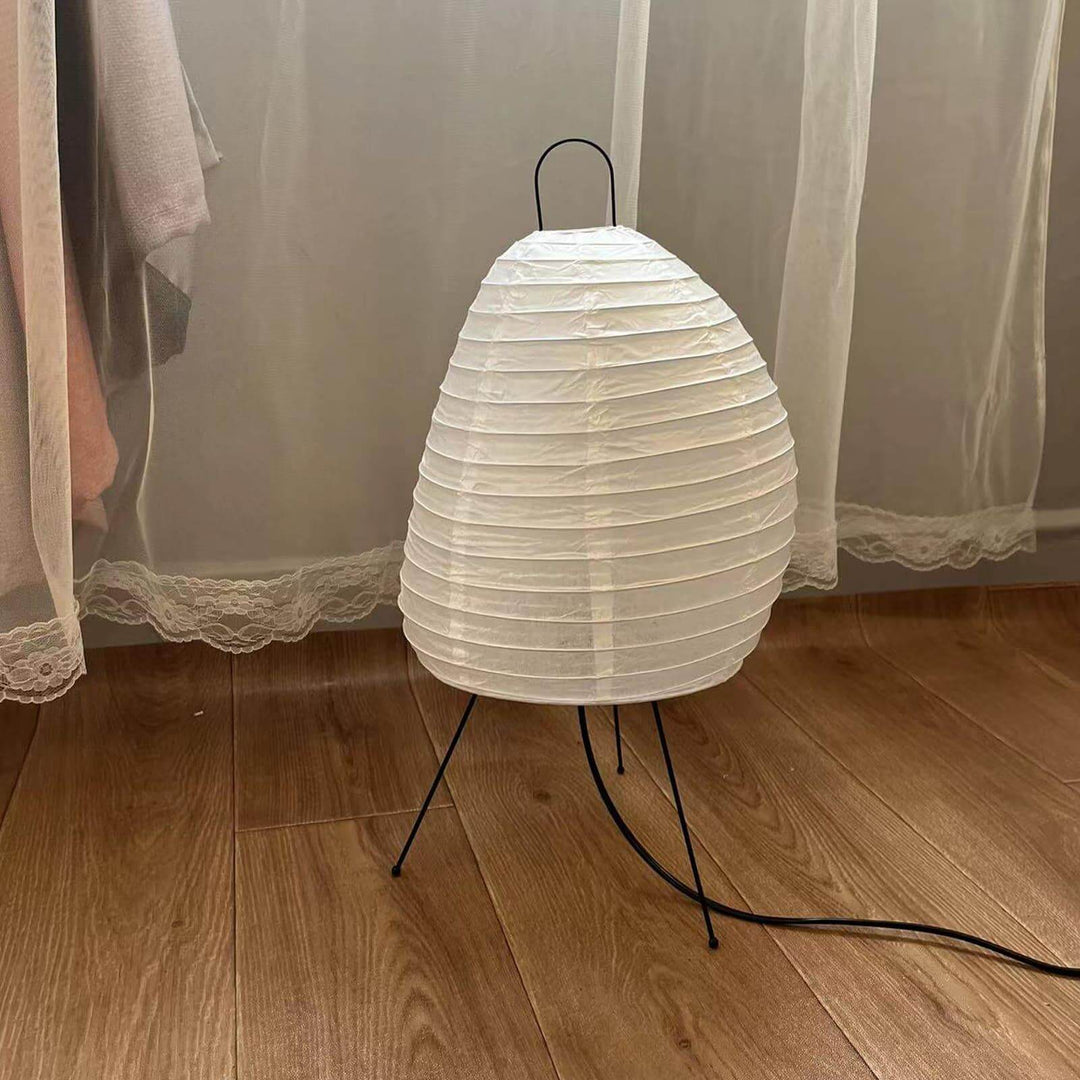 Angled view of the Akari 1N Table Lamp showing its paper texture and wire frame