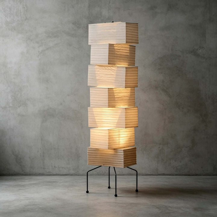 Akari UF4-L10 floor lamp with seven stacked ribbed paper shades on a slim black metal base