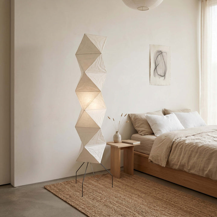 Akari UF4-L8 bedroom floor lamp beside a wood platform bed and minimalist nightstand