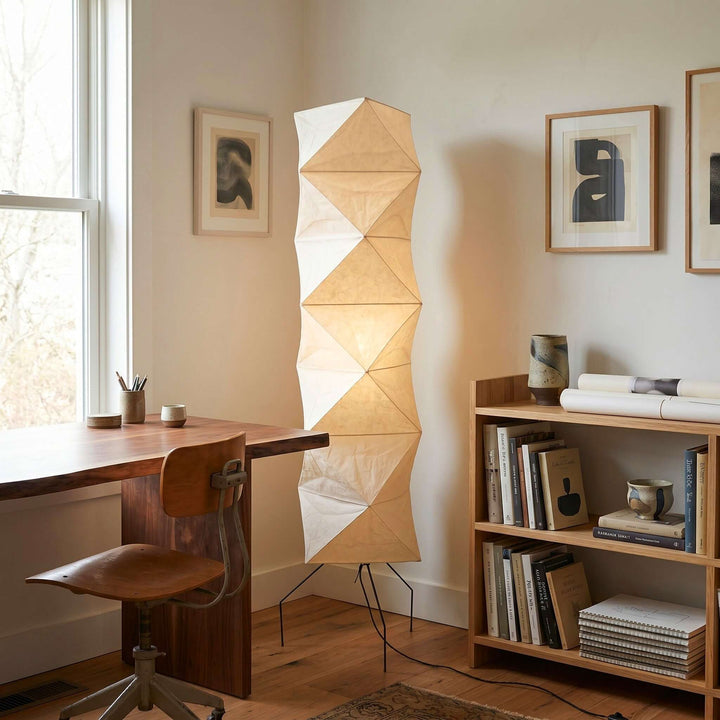 Akari UF4-L8 floor lamp beside a wood desk and bookcase in a warm home office