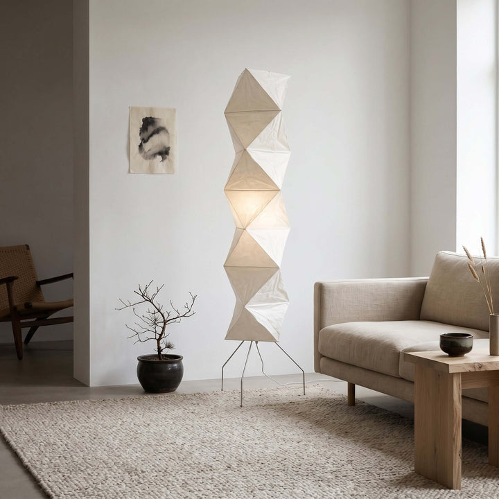 Akari UF4-L8 floor lamp beside a beige sofa and potted bonsai in a modern neutral living room