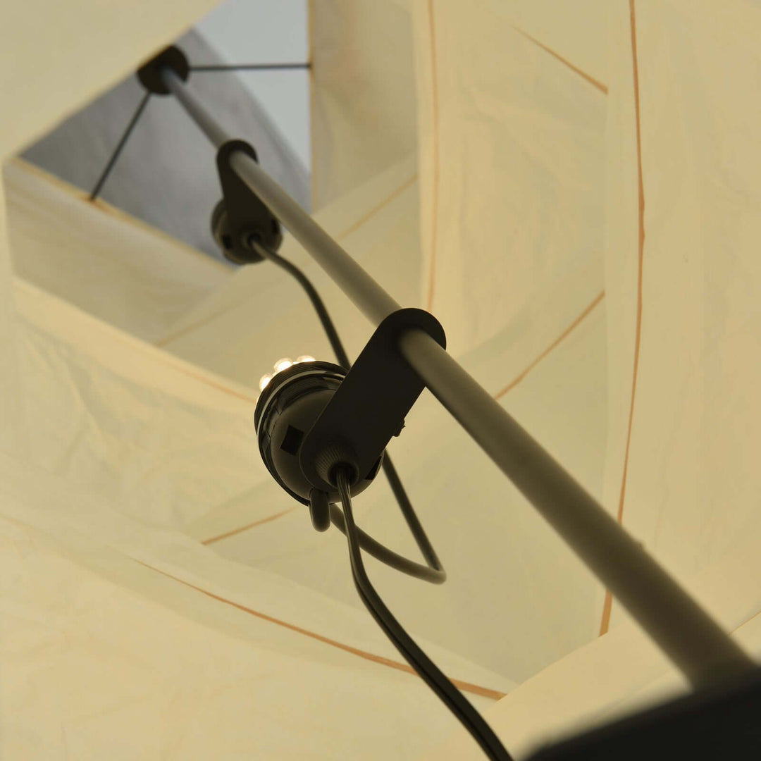 Interior close-up showing the Akari UF4-L8 floor lamp socket, support frame, and wiring