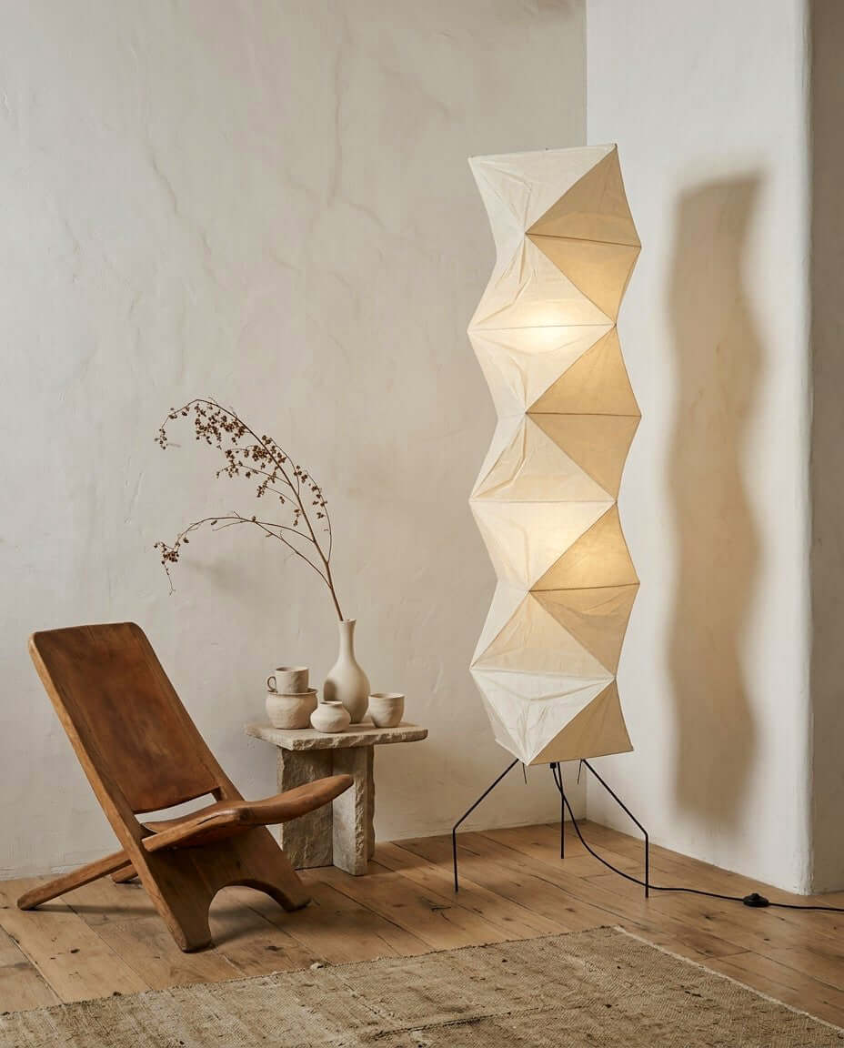 Akari UF4-L8 floor lamp beside a low wood chair and tea table in a minimalist reading corner