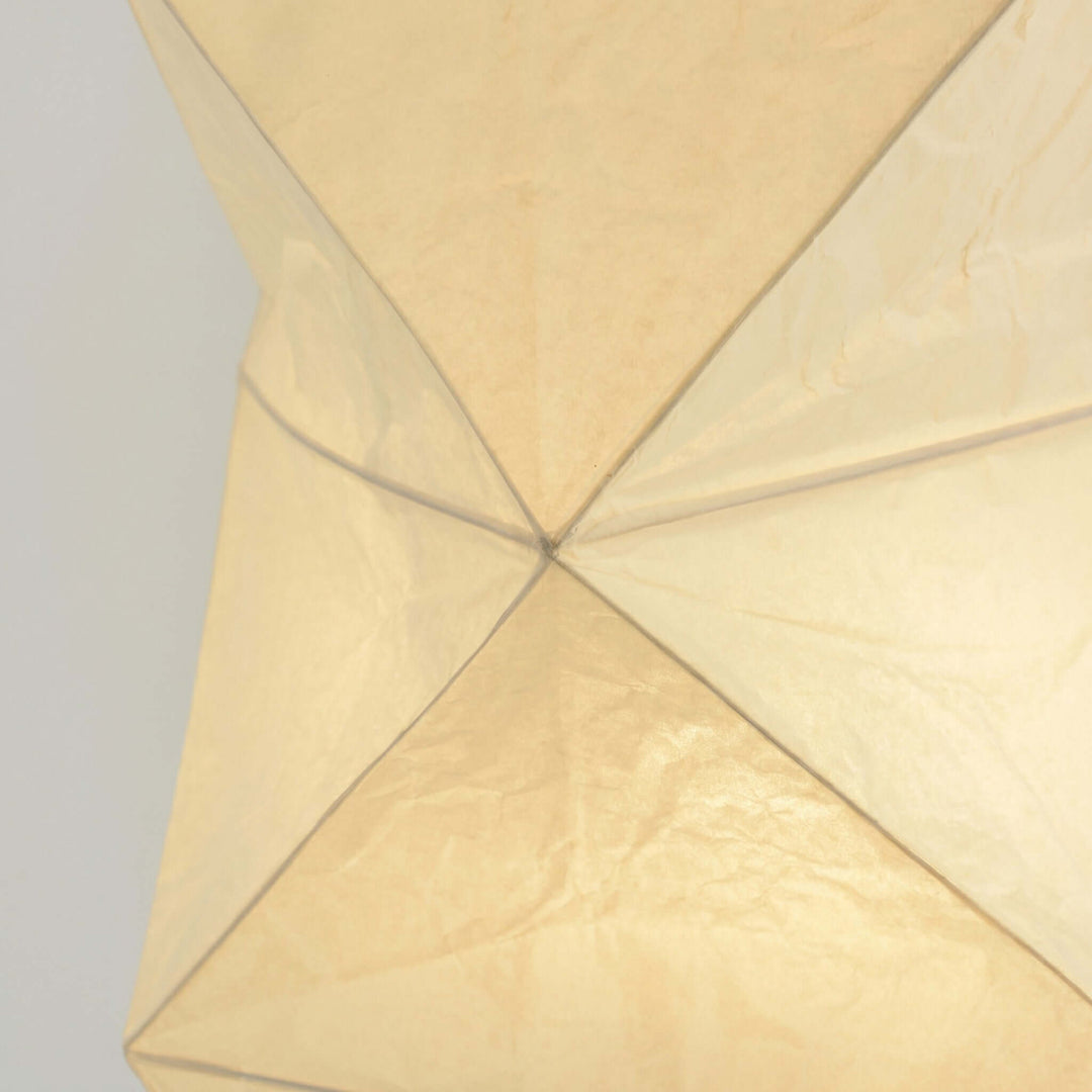 Close-up of the illuminated washi paper shade and geometric wire frame on the Akari UF4-L8 floor lamp