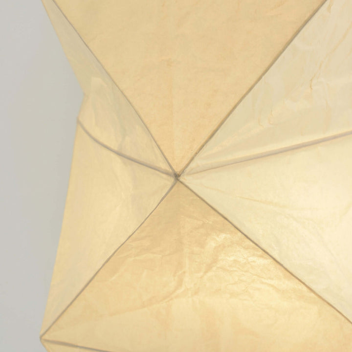 Close-up of the illuminated washi paper shade and geometric wire frame on the Akari UF4-L8 floor lamp