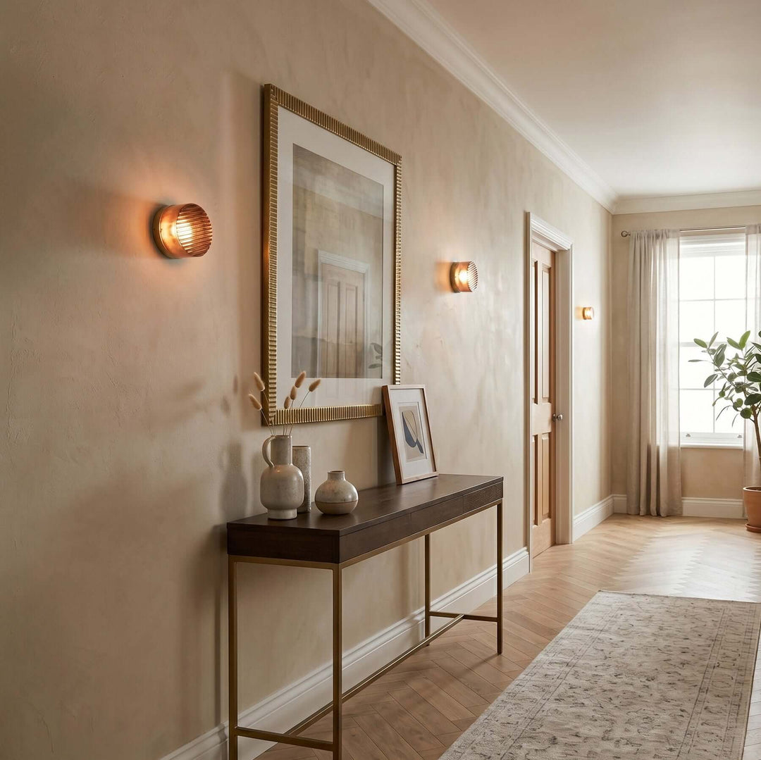 Amber Dimple wall sconces along a hallway above a console table.