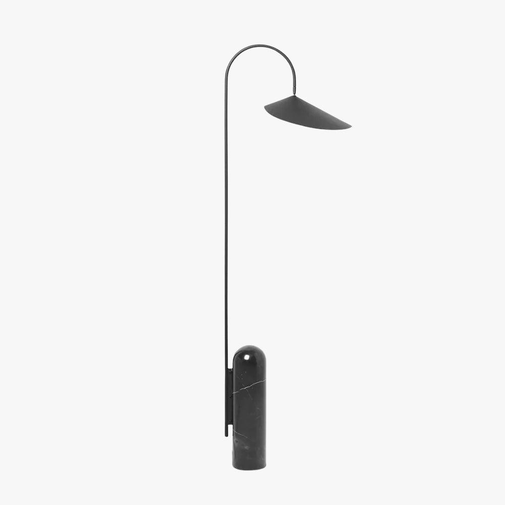 Black Arum floor lamp with a curved stem, wide metal shade, and cylindrical black marble base.