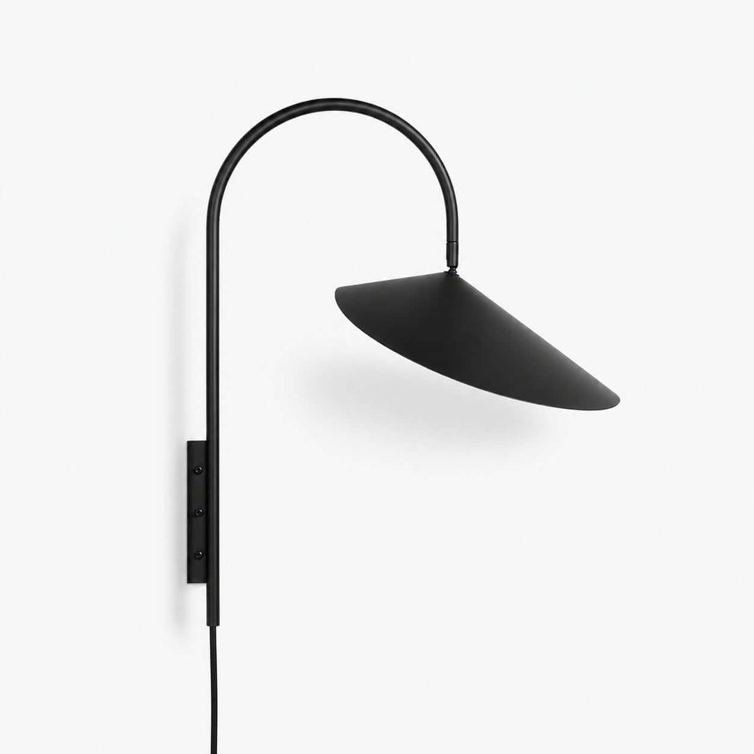 Black Arum plug-in wall sconce with a curved metal arm and wide conical shade on a white background