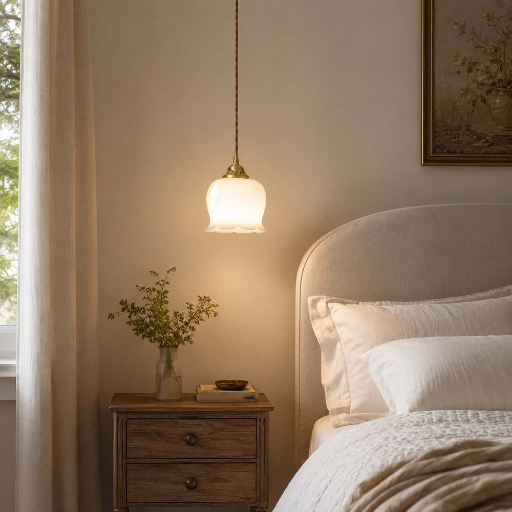 Warm Valley flower pendant light hanging beside a bed, styled as a compact bedroom pendant light