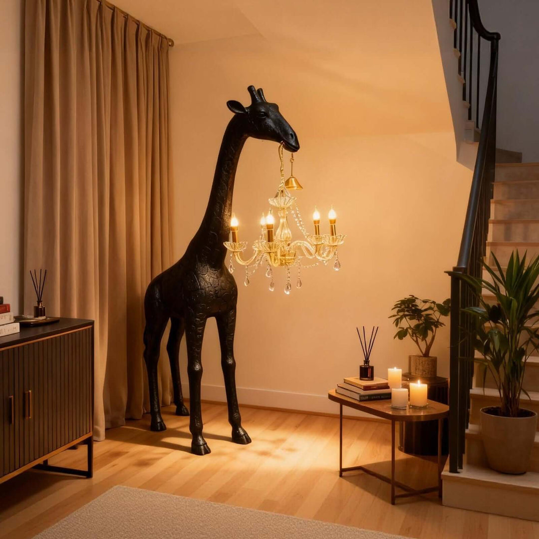 Black and gold giraffe floor lamp beside a staircase in a warm modern entryway