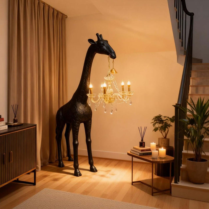 Black and gold giraffe floor lamp beside a staircase in a warm modern entryway
