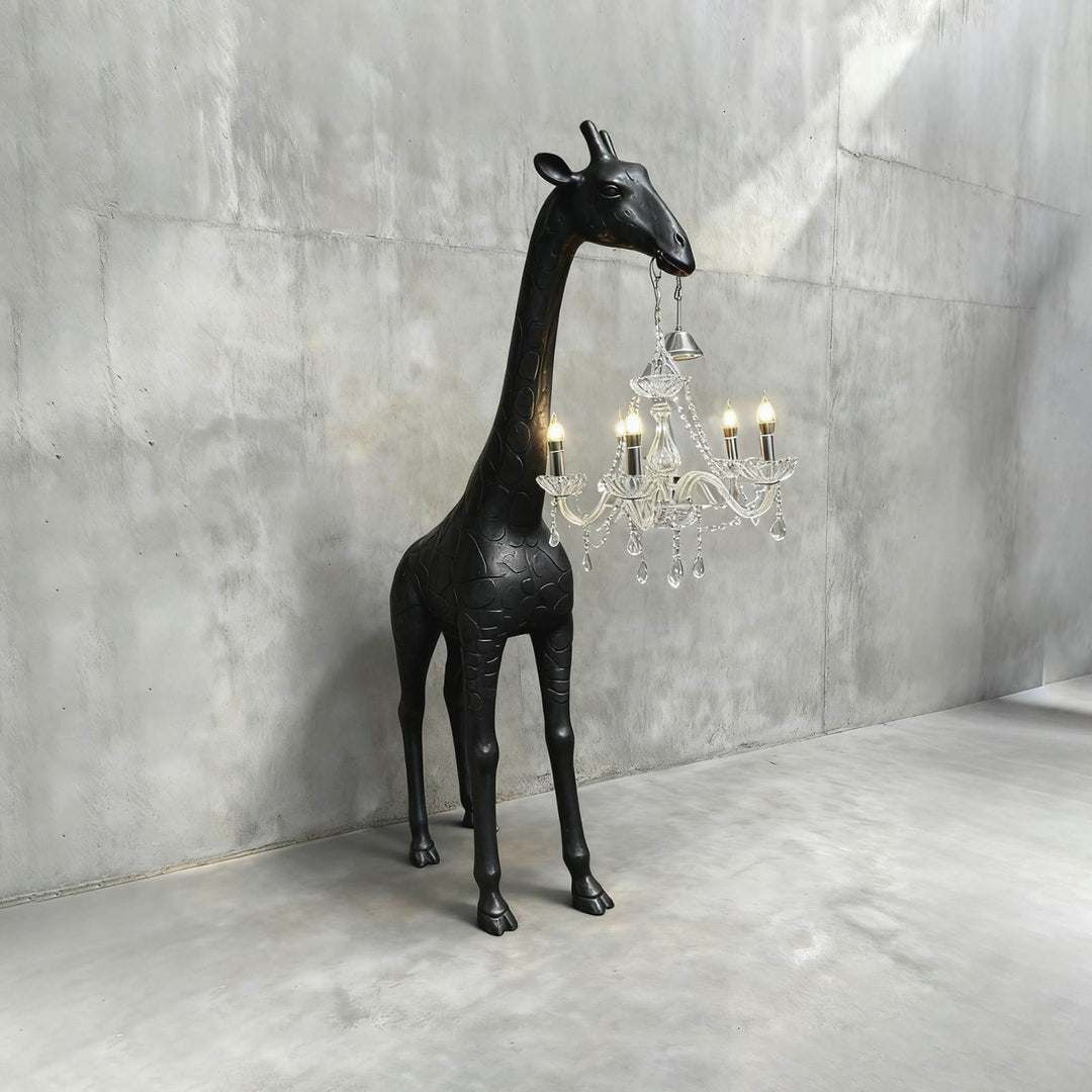 Black and silver giraffe floor lamp with an illuminated crystal chandelier