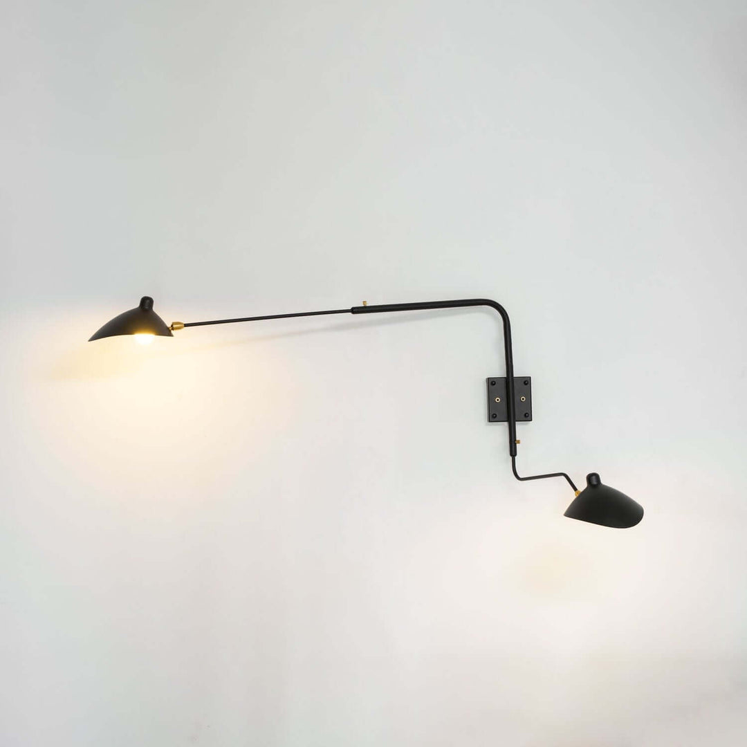 Black two-light swing arm wall sconce with both directional shades illuminated