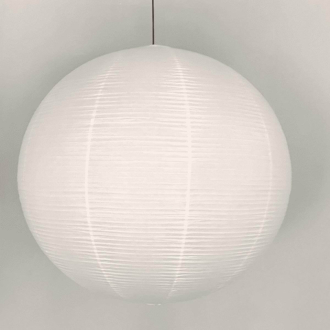 Close front view of a round rice paper pendant light with a black wire
