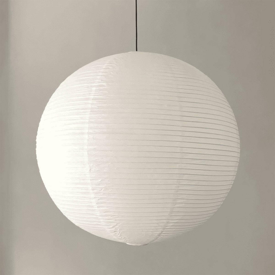 White round paper lantern pendant shown from the side with a black wire