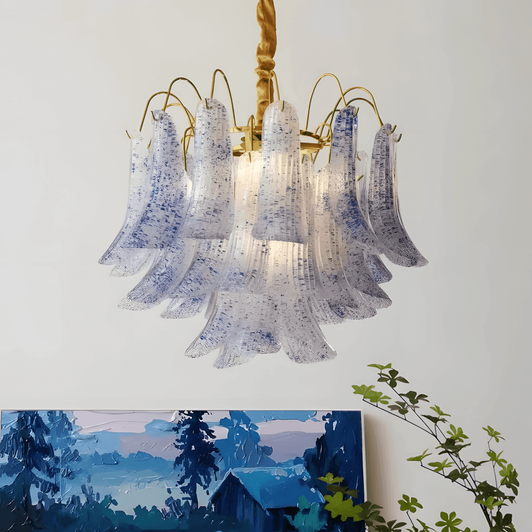 Blue Murano glass chandelier with tiered curved panels above blue landscape artwork