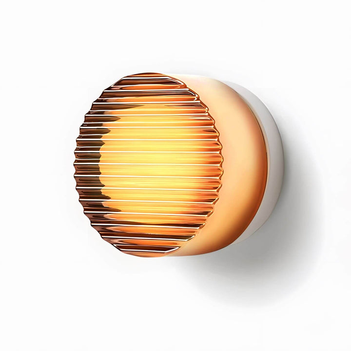 Bright amber ribbed glass wall sconce with a warm glow.