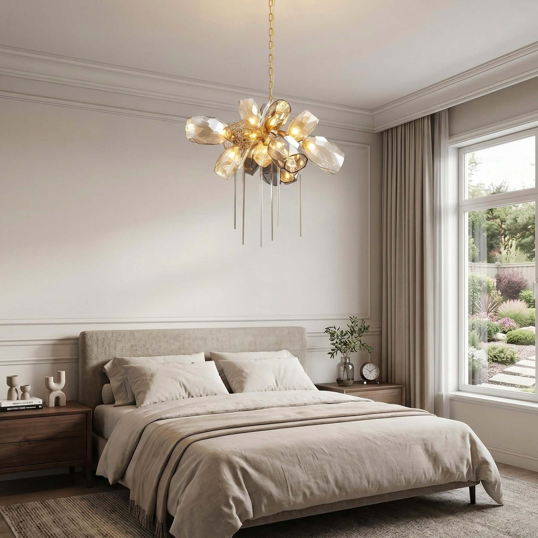 Round Britannica glass chandelier with warm lights and hanging rods above a neutral upholstered bed.
