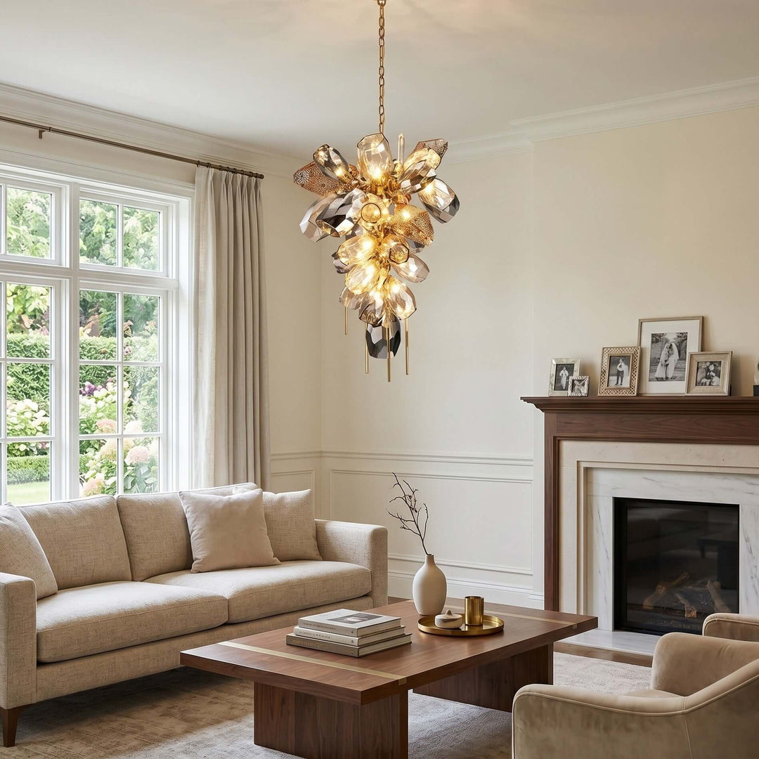 Vertical Britannica chandelier with clustered glass shades in a living room with a fireplace.