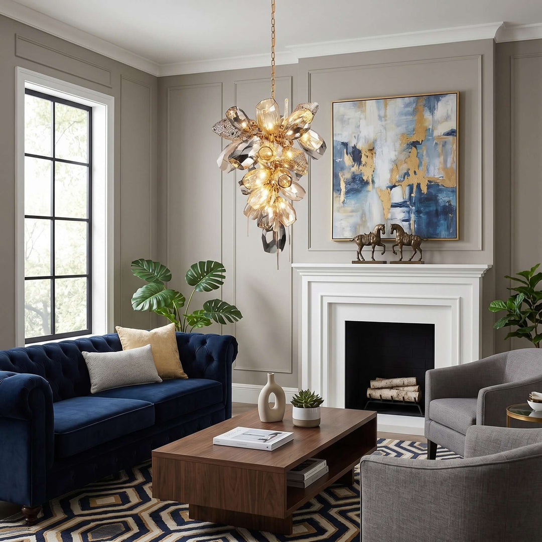 Illuminated vertical Britannica glass chandelier above a living room with a blue sofa and fireplace.