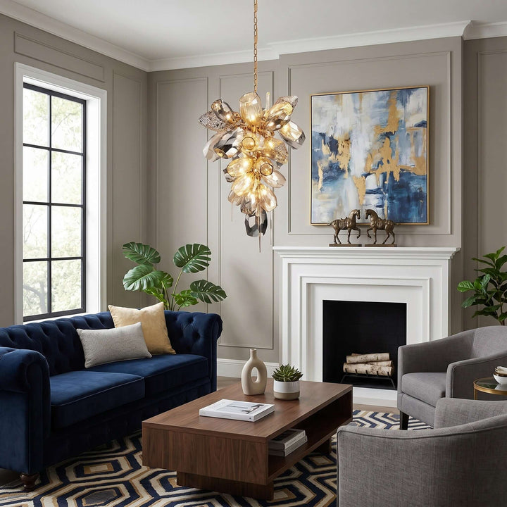 Illuminated vertical Britannica glass chandelier above a living room with a blue sofa and fireplace.