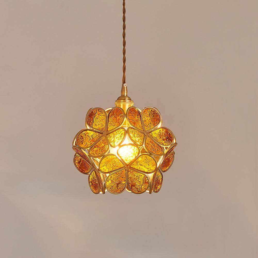 Brown stained glass petal pendant light illuminated against a neutral wall