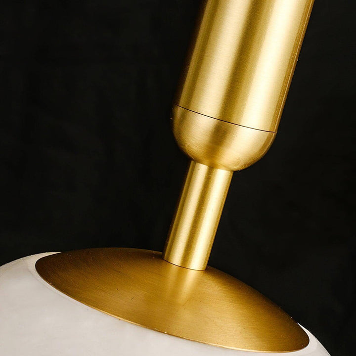 Close-up of the brushed brass stem and mounting plate on the Bosso alabaster pendant light