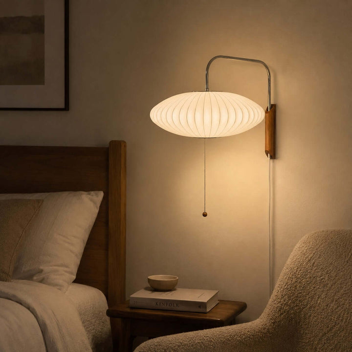 Glowing wide-shade Bubble Ball wall sconce creating warm bedside light in the evening