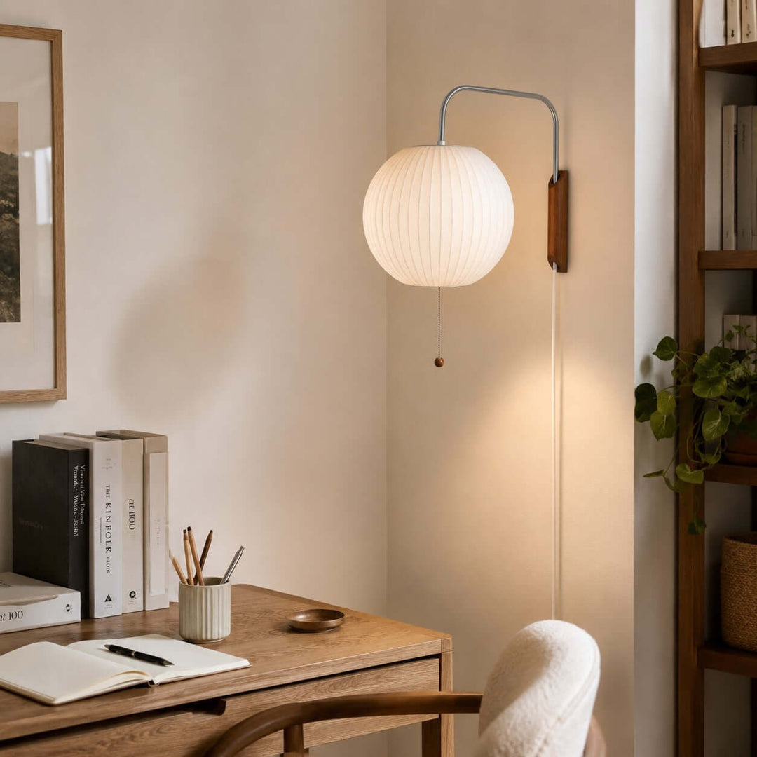 Globe-shade Bubble Ball wall sconce providing soft light above a home office desk