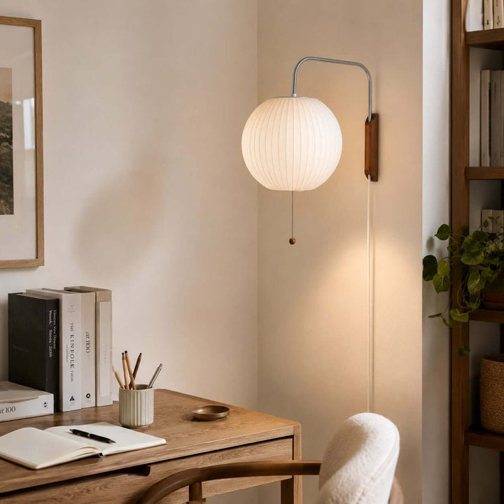 Globe-shade Bubble Ball wall sconce providing soft light above a home office desk