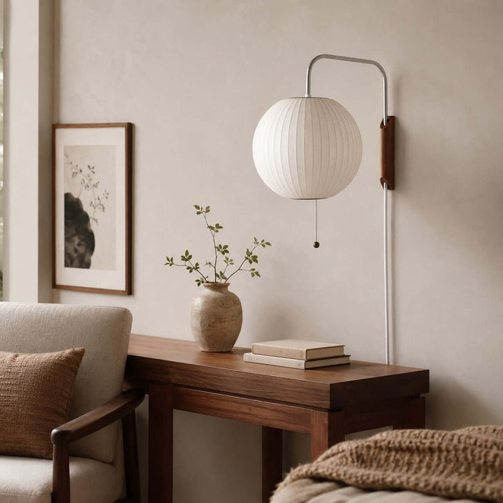 Globe Bubble Ball wall sconce above a wood console table in a neutral living room