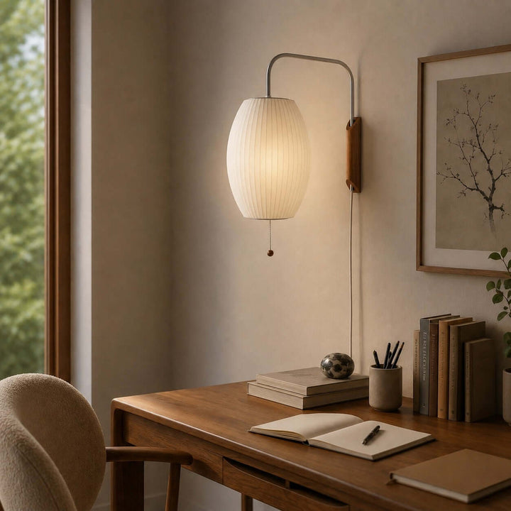 Bubble Ball wall sconce illuminating a wood desk in a cozy home office