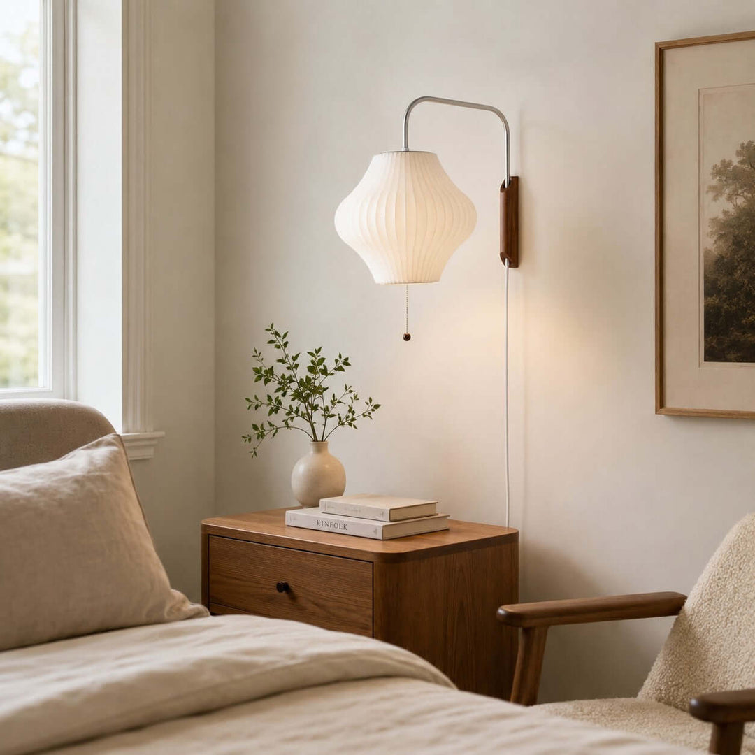 Lantern-shaped Bubble Ball wall sconce beside a bed and bright bedroom window