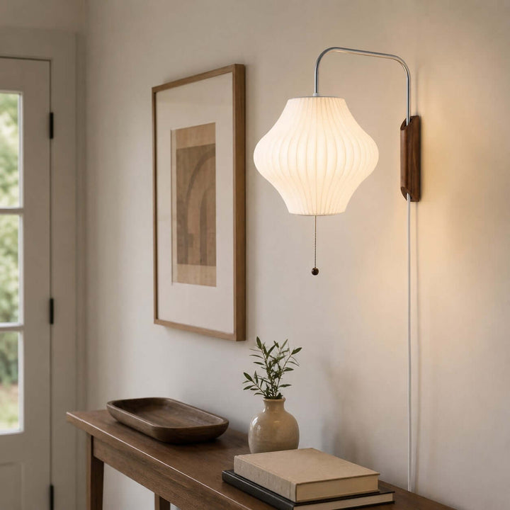 Lantern-shaped Bubble Ball wall sconce above a wood console table in a bright entryway