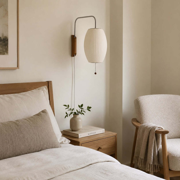 Oval Bubble Ball wall sconce beside a wood nightstand and upholstered bedroom chair