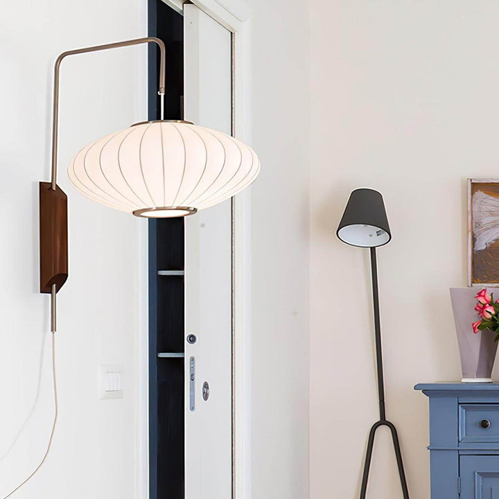 Wide Bubble Ball wall sconce mounted near a doorway in a bright modern interior