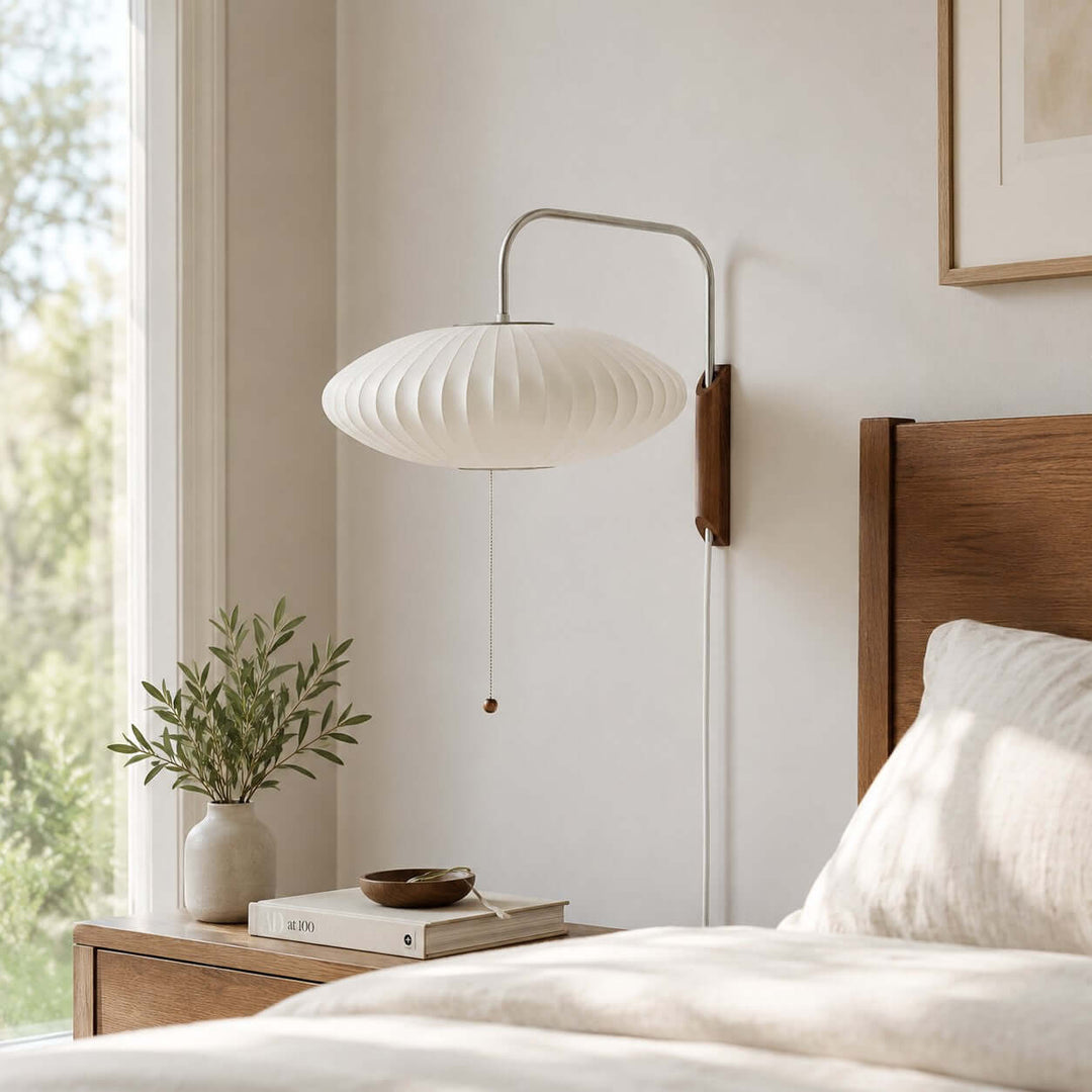 Wide Bubble Ball wall sconce mounted beside a sunlit bed and wood nightstand