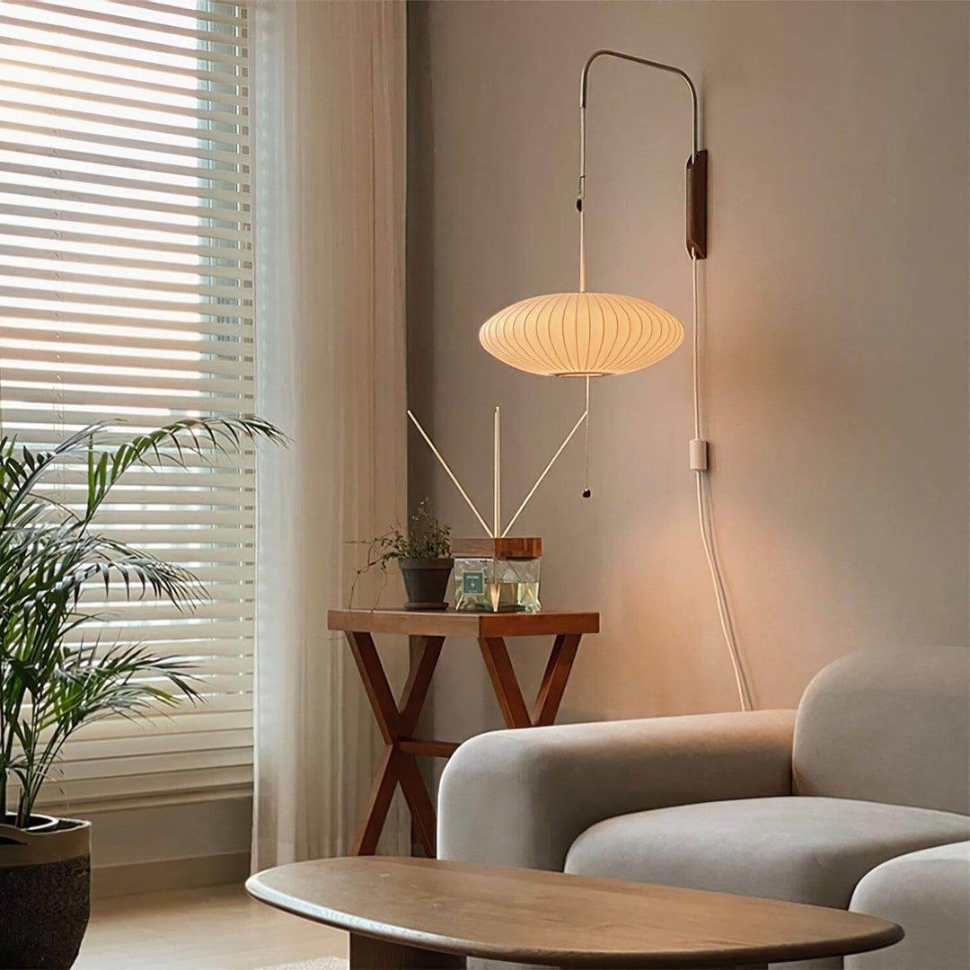 Plug-in Bubble Ball wall sconce beside a window and sofa in a casual living room