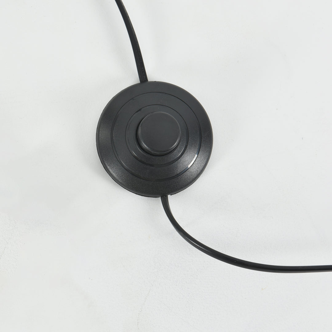Close-up of the Candied Glass Floor Lamp’s round black foot switch and power cord.